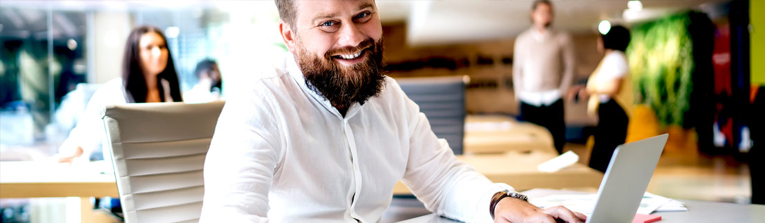 Happy smiling man in workplace